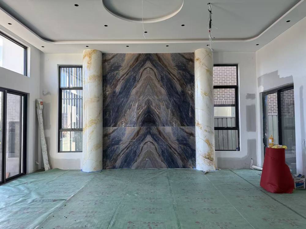 Living room with stone feature wall and marble-look columns